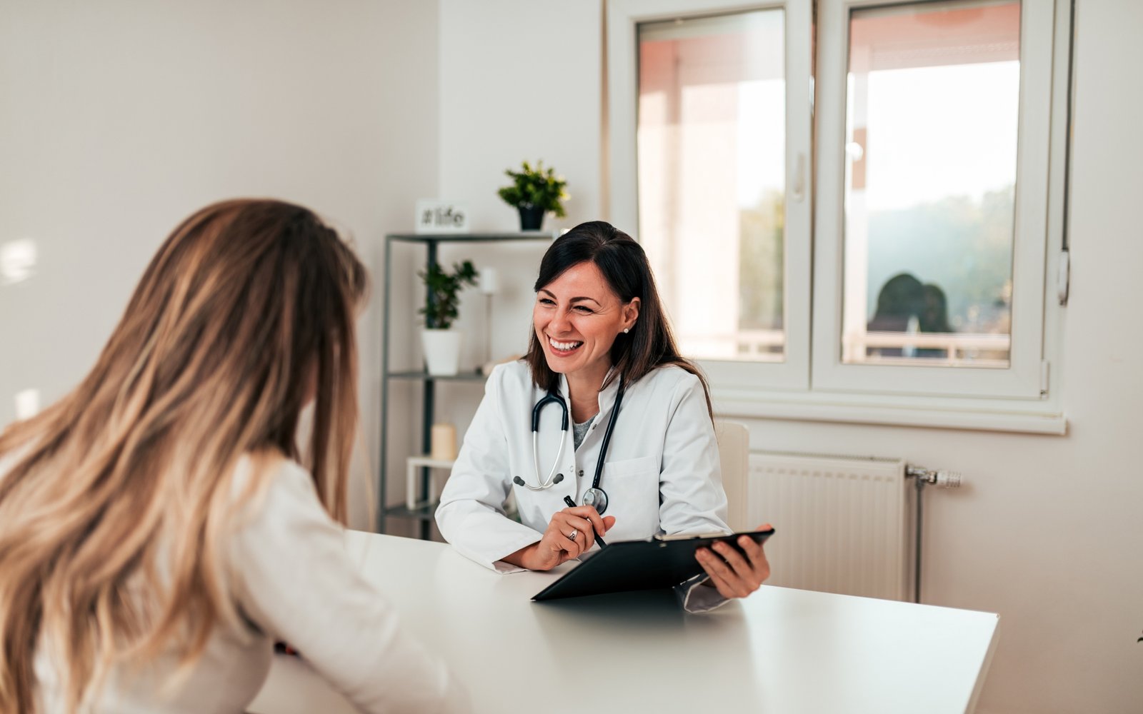 Médica acolhendo paciente em consulta